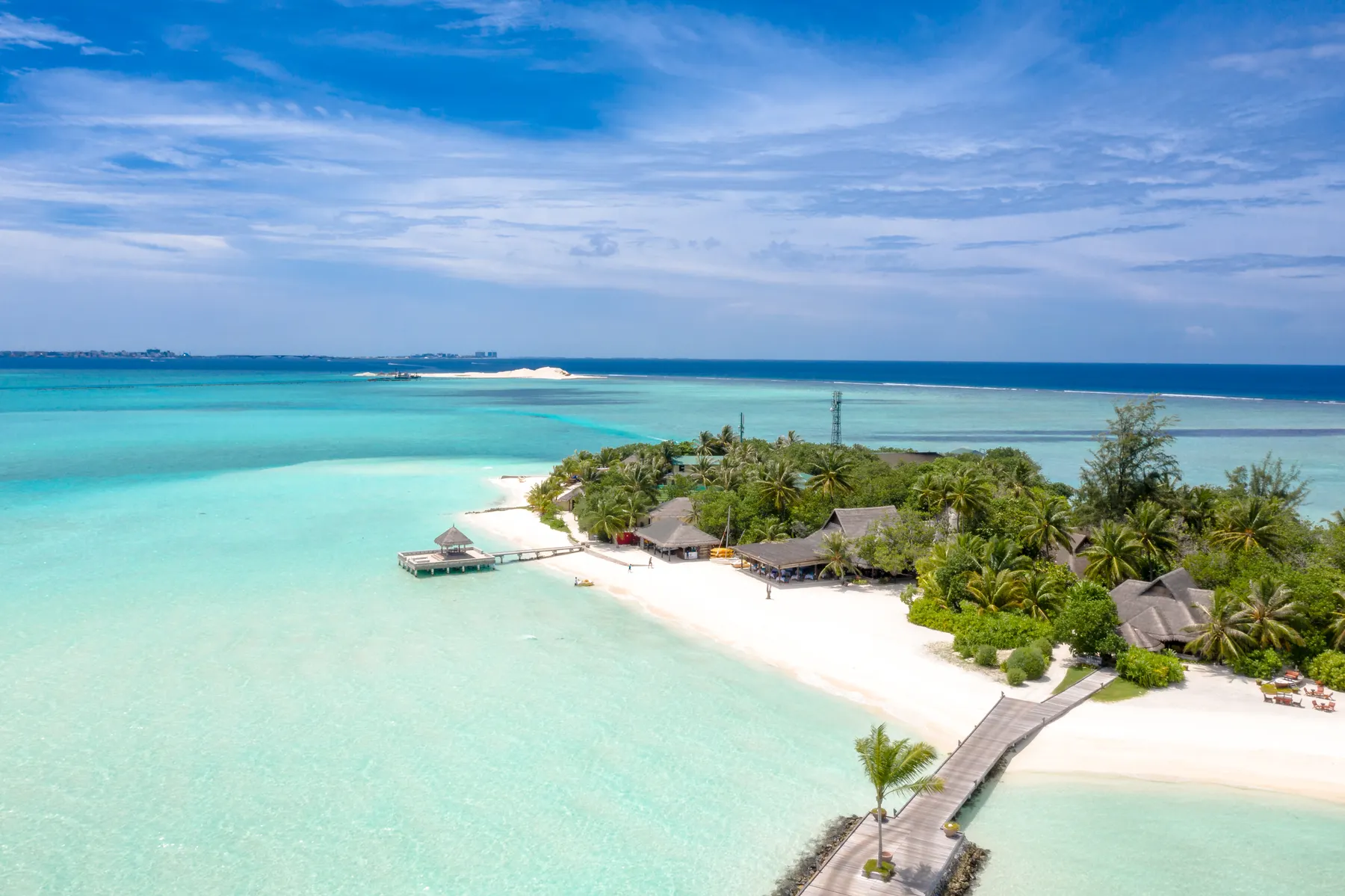 Aerial view of a tropical resort island surrounded by turquoise water