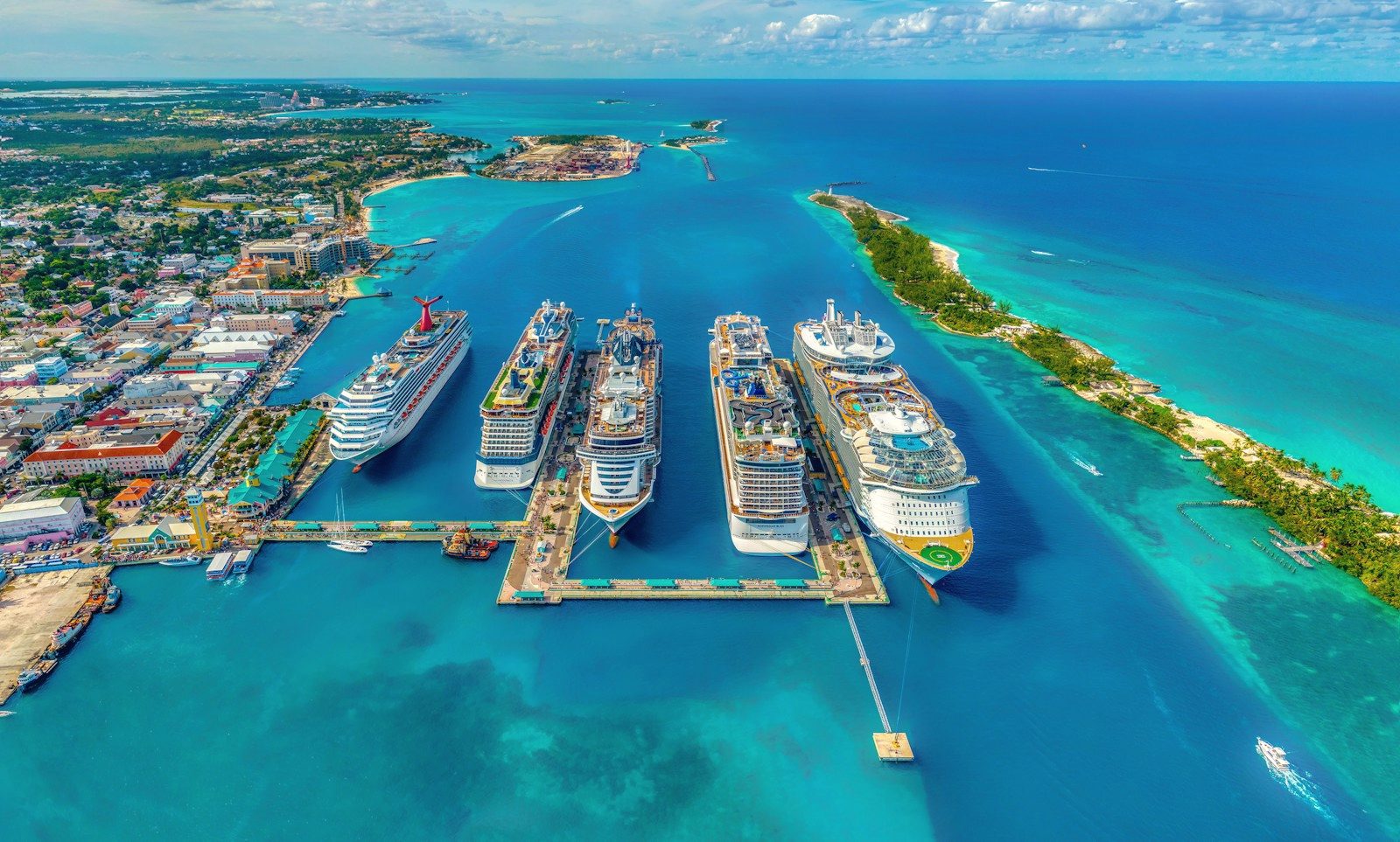 Cruise ships docked in a turquoise harbor