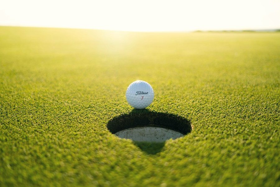 Golf ball on the lip of the cup