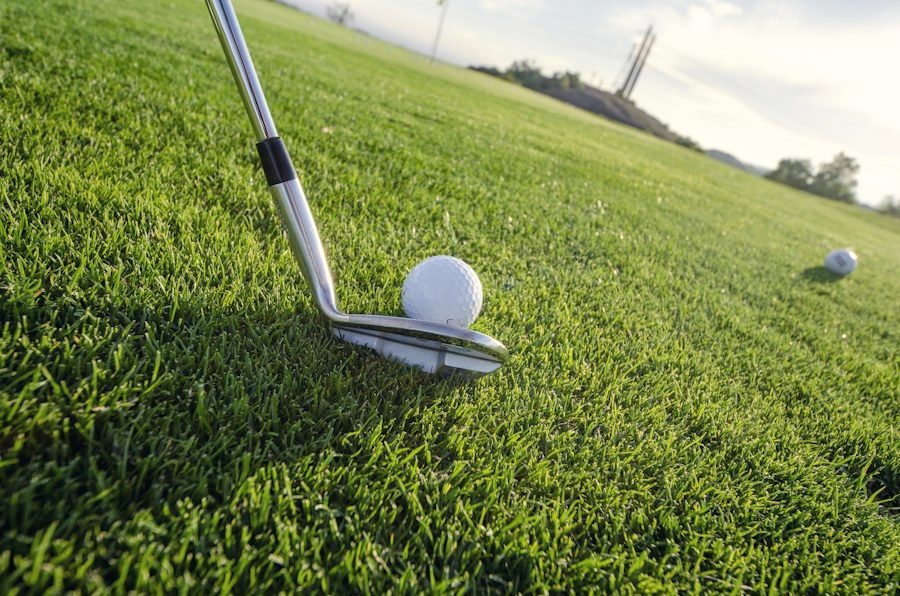 Iron addressing a golf ball